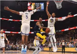  ?? JUSTIN FORD — GETTY IMAGES ?? The Grizzlies’ Ja Morant (12) looks to pass against the Warriors’ Otto Porter Jr. (32) during Game 2of the Western Conference Semifinals on Tuesday at FedExForum in Memphis, Tenn. The Grizzlies defeated the Warriors 106-101.