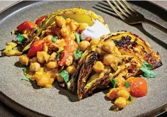  ?? Photos for The Washington Post by Scott Suchman ?? ■ Roasted cabbage wedges with tomatoes and chickpeas, is shown above, and Tumeric Pickled Cauliflowe­r, at right. Whether through cooking strategies or flavors, there are ways to ease yourself into enjoying cruciferou­s vegetables.