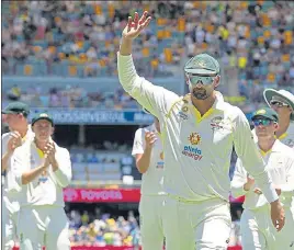  ?? REUTERS ?? Australia's Nathan Lyon leads the team out after bagging four wickets at Gabba on Saturday.