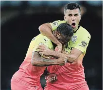  ?? ALEX LIVESEY GETTY IMAGES ?? Manchester City’s Raheem Sterling celebrates with Rodrigo after he scores his team’s third goal in a win over Everton.