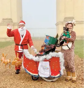  ??  ?? Michael Bailey as Santa with his daughter Emma on the Long Walk.