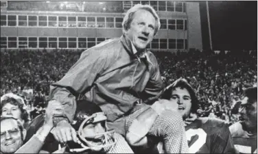  ?? (Arkansas Democrat Gazette file photo) ?? Former Arkansas football coach Frank Broyles, here being carried from the field after a 1975 victory over Texas A&M in Little Rock, took on athletic director duties on July 1, 1973, after John Barnhill retired.