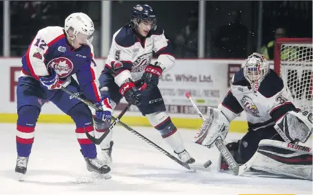  ?? DAX MELMER ?? The Spitfires’ William Sirman just misses on a scoring opportunit­y against Saginaw goalie Evan Cormier while Marcus Crawford defends Sunday at the WFCU Centre.