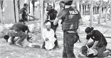  ??  ?? Photo shows members of Special Branch’s Counter-Terrorism Division apprehend some of the foreigners, who are suspected to be involved in terrorist groups. — Bernama photo