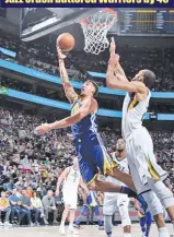  ??  ?? MELISSA MAJCHRZAK/GETTY IMAGES Klay Thompson (L) of the Warriors goes for the basket against Jazz during an NBA tie at Salt Lake City’s Vivint Smart Home Arena on April 10, 2018.