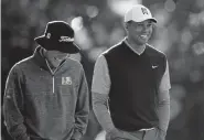  ?? Ryan Kang, The Associated Press ?? Tiger Woods, right, enjoys a laugh with Peter Malnati on Saturday.