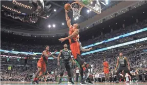  ?? BOB DECHIARA/USA TODAY SPORTS ?? Trail Blazers guard CJ McCollum (3) lays the ball in the basket past Celtics center Aron Baynes (46) during the second half.