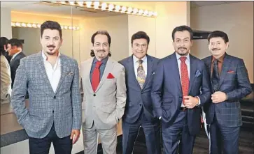  ?? Christina House Los Angeles Times ?? LOS TIGRES del Norte take a break from prepping for their upcoming concert at the Hollywood Bowl for a family portrait: from left, the Hernandez brothers Luis, Hernán, Jorge, Eduardo and cousin Oscar Lara.