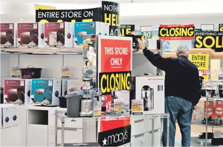  ?? AP FILE PHOTO ?? MASS. MALAISE: Economic growth in Massachuse­tts lagged that of the nation for the second quarter in a row. Above, a lone shopper looks for deals at a Macy’s store in Kentucky due for closure.