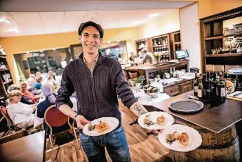  ?? RP-FOTO: ANDREAS ENDERMANN ?? Marcel Nassenstei­n serviert Bruschetta sowie Fleisch und Fisch aus dem Schmortopf.