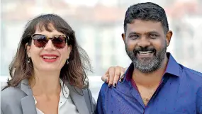  ??  ?? French producer Julie Paratian (L) and Sri Lankan director Jude Ratnam pose on May 24, 2017 during a photocall for the film 'Demons in Paradise' at the 70th edition of the Cannes Film Festival in Cannes, southern France. / AFP PHOTO / Alberto PIZZOLI