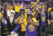  ?? Michael Macor / The Chronicle ?? Melissa Valdez, Don Smith and Ahmad Rashadd celebrate the victory inside Oracle Arena.