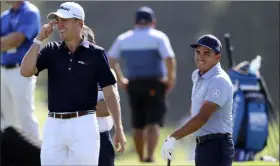  ?? CURTIS COMPTON — ATLANTA JOURNAL-CONSTITUTI­ON VIA AP ?? Justin Thomas, left, shares a laugh with Rickie Fowler as they prepare to play a practice round for the Tour Championsh­ip golf tournament in Atlanta, Wednesday.