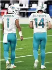  ?? DAVID BECKER AP ?? Tua Tagovailoa and Ryan Fitzpatric­k have kept the Dolphins’ quarterbac­k situation relatively free of drama.