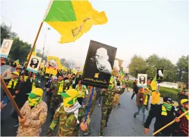  ?? (Thaier al-Sudani/Reuters) ?? KATAIB HEZBOLLAH militia gather ahead of the funeral of Iraqi militia commander Abu Mahdi al-Muhandis, who was killed in a US drone strike at Baghdad Airport, in Baghdad, Iraq, January 4. The group has carried out dozens of rocket attacks on bases housing US forces in Iraq.