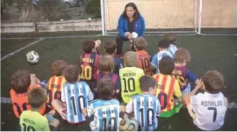  ??  ?? A boy goes against the grain at a soccer practice in Argentina by wearing a Cristiano Ronaldo jersey while his teammates donned that of local hero Lionel Messi. — AFP