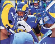  ?? Robert Gauthier / TNS ?? Los Angeles Rams defensive end Aaron Donald, center, rallies teammates before taking on the Tampa Bay Buccaneers in the NFC divisional playoff at Raymond James Stadium on Jan. 23.