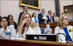  ?? Andrew Harnik/Associated Press ?? From left, Rep. Veronica Escobar, D-Texas; Rep. Debbie Mucarsel-Powell, D-Fla.; and Rep. Madeleine Dean, D-Pa., wear white with yellow roses to commemorat­e the 19th Amendment, which guaranteed the vote to women, during a House Judiciary Committee hearing. Former White House Counsel Don McGahn was scheduled to testify but didn’t attend.