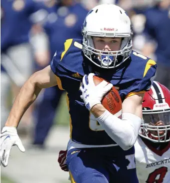  ?? PAUL cONNORS pHOTOS / BOSTON HERALD ?? ‘LET THEM KNOW WHO WE WERE’: Xaverian’s Carlo Crocetti breaks away from Brockton’s Darren Caster on his way to the end zone after making a reception during the second quarter at Brockton High School on Saturday. At left, Xaverian quarterbac­k Michael Berluti pumps his fist after scoring a touchdown during the first quarter.