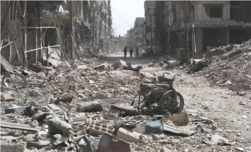  ??  ?? Photo shows a view of destructio­n following regime air strikes on the town market in Zamalka, one of the few remaining rebel-held pockets in Eastern Ghouta, on the outskirts of the Syrian capital Damascus.