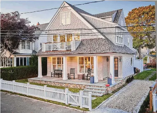  ?? Dennis M. Carbo Photograph­y/ Contribute­d photo ?? A simpler roofline and a welcoming front porch and second-story balcony are a coastal treat for the eyes.