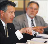  ?? CATHLEEN ALLISON/LAS VEGAS REVIEW-JOURNAL ?? Gov. Brian Sandoval and his chief of staff, Mike Willden, right, say that Nevada can address a potential problem of inmate overcrowdi­ng in the next two years without building another prison.