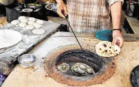  ??  ?? A cook makes rotis at the Verma dhaba near Palampur in Himachal Pradesh, India.