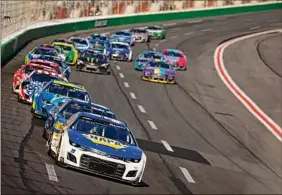  ?? Jared C. Tilton / Getty Images ?? Chase Elliott leads the field during the race at Atlanta Motor Speedway on Sunday. The win was his third of the season.