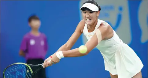  ?? XINHUA ?? Chinese teen Wang Xiyu returns against Daria Kasatkina of Russia during the second round of the WTA Wuhan Open on Tuesday.