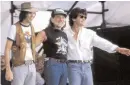  ?? The Associated Press file photo ?? Farm Aid I was held on this day in 1985. Organizers, from left, Neil Young, Willie Nelson and John Mellencamp take a bow.