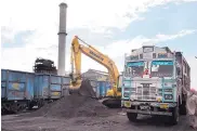  ?? VAISHNAVEE SHARMA/ASSOCIATED PRESS ?? Domestical­ly produced petroleum coke is loaded onto a truck at a railway station in Rampur, India, about 130 miles from New Delhi, to be transporte­d to factories.