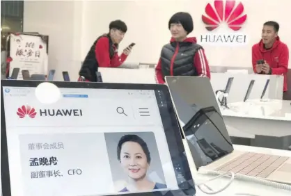  ?? Associated Press ?? A profile of Huawei’s chief financial officer Meng Wanzhou is displayed at a Huawei store in Beijing on Thursday. BEIJING: