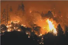  ?? Scott Stoddard / Grants Pass (Ore.) Daily Courier ?? Flames from the Lava Fire burn along a ridge near U.S. Highway 97 and Big Springs Road north of Weed (Siskiyou County) near Lake Shastina.