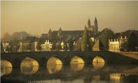  ?? Photograph: Frans Lemmens/Getty Images ?? The River Maas and Maastricht at dawn.