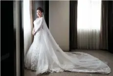  ??  ?? JASMIN ELLEN SARMIENTO in her bridal finery