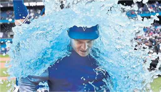  ?? RICHARD LAUTENS TORONTO STAR FILE PHOTO ?? John Gibbons gets an on-field shower, courtesy of centre fielder Kevin Pillar, after his final game as manager of the Blue Jays in September.