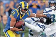  ?? [ALEX GALLARDO/THE ASSOCIATED PRESS] ?? Rams wide receiver Robert Woods, left, pushes away Seahawks defensive back Delano Hill during the second half Sunday in Los Angeles. The Rams won 36-31.