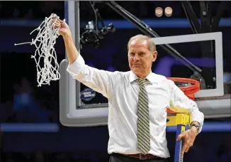  ?? HARRY HOW / GETTY IMAGES ?? Head coach John Beilein of Michigan, seeking his first NCAA title, cuts down the net after the Wolverines’ 58-54 victory against Florida State in the tournament’s West Regional final on March 24 in Los Angeles.