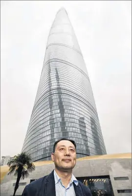  ?? Nick May
For The Times ?? JUN XIA, the design principal for Gensler on Shanghai Tower, stands in front of the building, whose guitar- pick- shaped form rotates 120 degrees as it tapers.