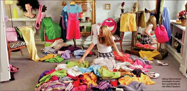  ??  ?? Alicia Silverston­e attempts to sort her wardrobe in the film Clueless