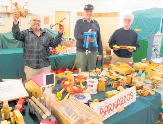  ??  ?? Pinocchio toymakers from left: Alan Thornton, Bill Sewell and Allan Sanson with the Christmas wooden toys for charities.