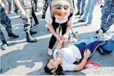  ?? — AFP ?? A protester loses consciousn­ess as riot police officers remove anti-government protesters blocking the road at the ring-bridge in Beirut on Thursday.