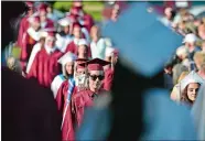  ?? TIM MARTIN/THE DAY ?? Members of the Wheeler High School Class of 2018 make their way through the audience during the procession­al portion of the school’s 62nd commenceme­nt in North Stonington on Thursday. Go to www.theday.com for a list of graduates and more photos.