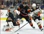  ?? TOM MIHALEK — THE ASSOCIATED PRESS ?? Flyers goalie Carter Hart, left, made 30 saves against the Ducks and tied an NHL rookie record with his eighth straight victory.