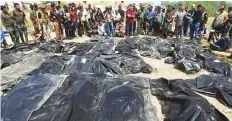  ?? AFP ?? Residents observe body-bags containing remains of people believed to have been slain by Daesh in Tikrit.
