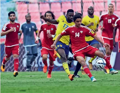  ?? Photo courtesy UAE FA ?? UAE’s Rayan Yaslam (No 14) makes his way past Gabon players. Also seen is Amer Abdulrahma­n (No 5). —