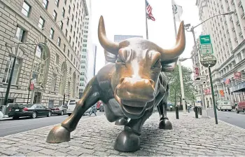 ??  ?? LANDMARK: The Italian artist’s famous Charging Bull statue in New York City.