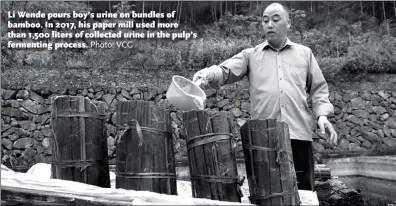  ?? Photo: VCG ?? Li Wende pours boy’s urine on bundles of bamboo. In 2017, his paper mill used more than 1,500 liters of collected urine in the pulp’s fermenting process.