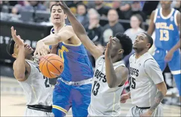  ?? David Zalubowski Associated Press ?? ALEX OLESINSKI battles the Buffaloes for a rebound on a night when the Bruins were playing catch-up most of the time. UCLA fell to 2-6 in Pac-12 games on the road entering Saturday’s season finale at USC.