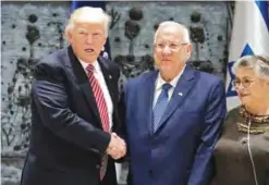  ??  ?? JERUSALEM: US President Donald Trump shakes hands with Israeli President Reuven Rivlin and his wife Nehama after signing the guest book at the President’s Residence in Jerusalem.—AFP